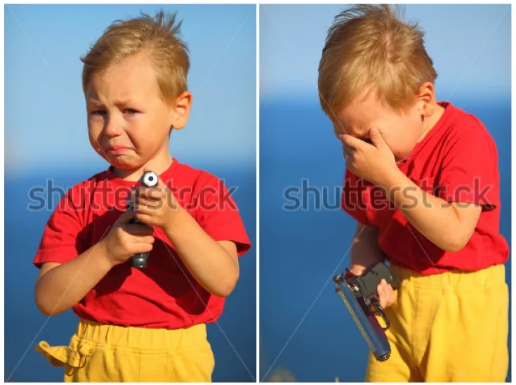 Crying boy with gun.jpg